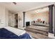 Spacious main bedroom leads to a cozy sitting area with a gray sofa at 10091 Sand Key St, Las Vegas, NV 89178