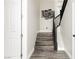 View of staircase with hardwood steps, black handrail, and modern art at 10091 Sand Key St, Las Vegas, NV 89178