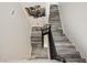 Stairway with modern black railing and contemporary flooring with art piece on the ceiling at 10091 Sand Key St, Las Vegas, NV 89178