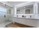 Modern bathroom featuring a double vanity, a glass-enclosed shower, and recessed lighting at 10809 Garden Mist Dr # 2072, Las Vegas, NV 89135