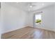 Bright bedroom with a ceiling fan, wood-look floors, and a view of the neighborhood through a window at 10809 Garden Mist Dr # 2072, Las Vegas, NV 89135