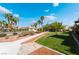 Well-maintained common area with lush green grass, palm trees, and manicured landscaping at 10809 Garden Mist Dr # 2072, Las Vegas, NV 89135