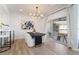 A modern dining room features an elegant light fixture and a view of the outdoor patio at 10809 Garden Mist Dr # 2072, Las Vegas, NV 89135