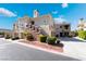 Attractive multi-unit condo complex featuring desert landscaping, attached garages, and private balconies at 10809 Garden Mist Dr # 2072, Las Vegas, NV 89135