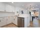 Modern kitchen with white cabinets, stainless steel appliances, and quartz countertops at 10809 Garden Mist Dr # 2072, Las Vegas, NV 89135