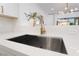 This modern kitchen features a stainless steel sink with modern fixtures and white countertops at 10809 Garden Mist Dr # 2072, Las Vegas, NV 89135