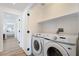 Laundry room featuring new washer and dryer, with white cabinets and neutral paint at 10809 Garden Mist Dr # 2072, Las Vegas, NV 89135