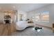 Open-concept living room with stylish furniture, modern lighting, and large windows at 10809 Garden Mist Dr # 2072, Las Vegas, NV 89135