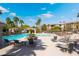 Resort-style pool area with lounge chairs, palm trees, and a covered seating area at 10809 Garden Mist Dr # 2072, Las Vegas, NV 89135