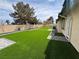 Lush artificial grass and stone pavers create a low-maintenance backyard oasis, perfect for relaxation and outdoor enjoyment at 1104 Oak Tree Ln, Las Vegas, NV 89108