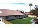 A well-maintained backyard featuring lush artificial grass and beautiful stone pavers for elegant landscaping and low maintenance at 1104 Oak Tree Ln, Las Vegas, NV 89108