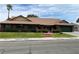 Inviting single-story brick home with a lush green lawn, mature landscaping, and a spacious driveway at 1104 Oak Tree Ln, Las Vegas, NV 89108