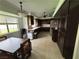 Functional kitchen featuring dark wood cabinets, tile countertops, and essential appliances at 1104 Oak Tree Ln, Las Vegas, NV 89108