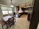 Functional kitchen featuring dark wood cabinets, tile countertops, and essential appliances at 1104 Oak Tree Ln, Las Vegas, NV 89108
