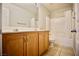 Bathroom with a double sink wood vanity and shower over tub at 1241 Gingerbread Man Ave, Las Vegas, NV 89183