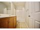 Bathroom featuring a wood vanity, shower over tub, and neutral tiling at 1241 Gingerbread Man Ave, Las Vegas, NV 89183
