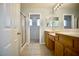 The bathroom has dual sinks, a tiled floor and walk-in shower at 1241 Gingerbread Man Ave, Las Vegas, NV 89183