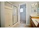 This bathroom has dual sinks, a walk-in shower, a tiled floor and a walk-in closet at 1241 Gingerbread Man Ave, Las Vegas, NV 89183