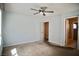 This is a carpeted bedroom with a ceiling fan, light blue walls and two doorways at 1241 Gingerbread Man Ave, Las Vegas, NV 89183