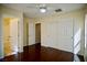 Bedroom featuring hardwood floors, a closet, and easy access to the en-suite bathroom at 1241 Gingerbread Man Ave, Las Vegas, NV 89183
