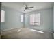 This bedroom has light blue walls, a ceiling fan and two windows that let in natural light at 1241 Gingerbread Man Ave, Las Vegas, NV 89183