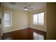 Bedroom with hardwood floors, ceiling fan, and multiple windows at 1241 Gingerbread Man Ave, Las Vegas, NV 89183