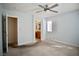Carpeted bedroom with a ceiling fan, a window, and a view into the bathroom at 1241 Gingerbread Man Ave, Las Vegas, NV 89183