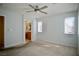 Carpeted bedroom with a ceiling fan, a window, and a view into the bathroom at 1241 Gingerbread Man Ave, Las Vegas, NV 89183