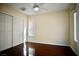 Bedroom with dark hardwood floors, ceiling fan, and large closet doors at 1241 Gingerbread Man Ave, Las Vegas, NV 89183