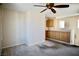 Living room featuring carpeted floors, ceiling fan, and custom built-in cabinetry at 1241 Gingerbread Man Ave, Las Vegas, NV 89183