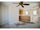 Cozy living room featuring carpeted floors, a ceiling fan, and custom built-ins at 1241 Gingerbread Man Ave, Las Vegas, NV 89183
