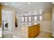 Open floor plan featuring a living room adjacent to kitchen island with a staircase nearby at 1241 Gingerbread Man Ave, Las Vegas, NV 89183