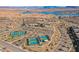 Aerial shot of community amenities, including the pool and blue tennis courts near the lake at 127 Crimson Cactus Ave, Henderson, NV 89011