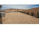 A low maintenance desert landscaped backyard with stone, minimal shrubs, and a block wall at 127 Crimson Cactus Ave, Henderson, NV 89011
