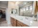 Bathroom vanity with dual sinks, modern faucets, white countertop and storage at 127 Crimson Cactus Ave, Henderson, NV 89011