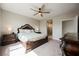 Primary bedroom suite features a ceiling fan, a window providing natural light, and warm neutral decor at 127 Crimson Cactus Ave, Henderson, NV 89011