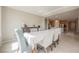 Bright dining area with tiled floors features table with seating for six and views into the kitchen at 127 Crimson Cactus Ave, Henderson, NV 89011