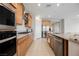 Modern kitchen with stainless steel appliances, granite countertops, ample cabinetry, and tile flooring at 127 Crimson Cactus Ave, Henderson, NV 89011