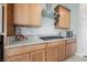 Gourmet kitchen features stainless steel appliances, granite countertops, gas cooktop, and custom cabinetry at 127 Crimson Cactus Ave, Henderson, NV 89011