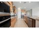 Modern kitchen with stainless steel appliances, granite countertops, gas cooktop, and tile flooring at 127 Crimson Cactus Ave, Henderson, NV 89011