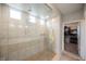 Large step-in shower with dual shower heads, tiled walls and bench seating offers spa-like experience at 127 Crimson Cactus Ave, Henderson, NV 89011