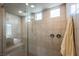 Large step-in shower with dual shower heads, tiled walls and bench seating offers spa-like experience at 127 Crimson Cactus Ave, Henderson, NV 89011