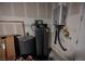 Image shows a tankless water heater and a water softener system in the utility room at 127 Crimson Cactus Ave, Henderson, NV 89011