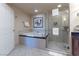 Well-lit bathroom featuring a soaking tub, glass shower, and modern fixtures at 135 E Harmon Ave # 2104, Las Vegas, NV 89109