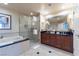 Luxurious bathroom with dual sinks, a soaking tub, and a glass-enclosed shower at 135 E Harmon Ave # 2104, Las Vegas, NV 89109