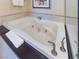 Luxurious soaking tub with black marble counter and silver fixtures in a well-lit bathroom at 135 E Harmon Ave # 2104, Las Vegas, NV 89109