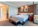 King bed and bathroom entrance within a room with dark brown accent wall at 135 E Harmon Ave # 2104, Las Vegas, NV 89109