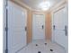 Hallway with tiled flooring and white doors, creating a clean and bright entrance to living spaces at 135 E Harmon Ave # 2104, Las Vegas, NV 89109
