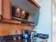 Kitchenette with sleek black countertops features modern appliances at 135 E Harmon Ave # 2104, Las Vegas, NV 89109