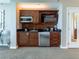 A well-equipped kitchenette boasts modern appliances, wood cabinets, and a sleek design at 135 E Harmon Ave # 2104, Las Vegas, NV 89109